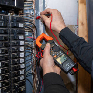 Home inspector testing home circuit breaker.